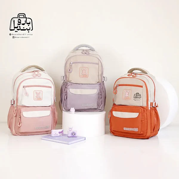 تصویر اختصاصی از نمای جلوی کوله پشتی مدرسه حاصل ۱-۱۵۱۴ در رنگ نارنجی صورتی یاسی